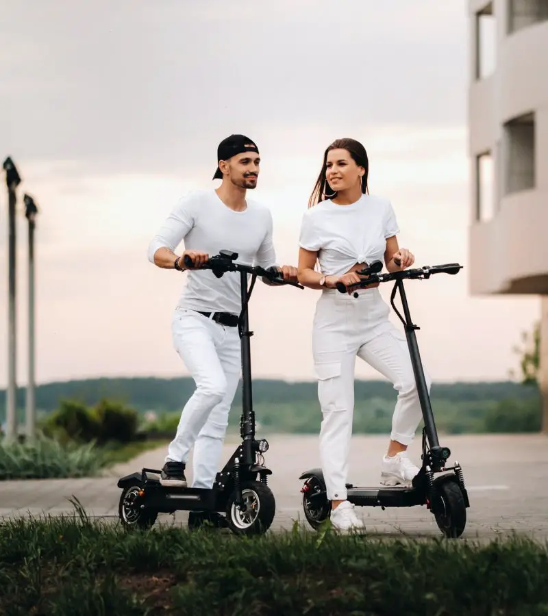 a-girl-and-a-guy-are-walking-on-electric-scooters-around-the-city-a-couple-in-love-on-scooters-2.jpg